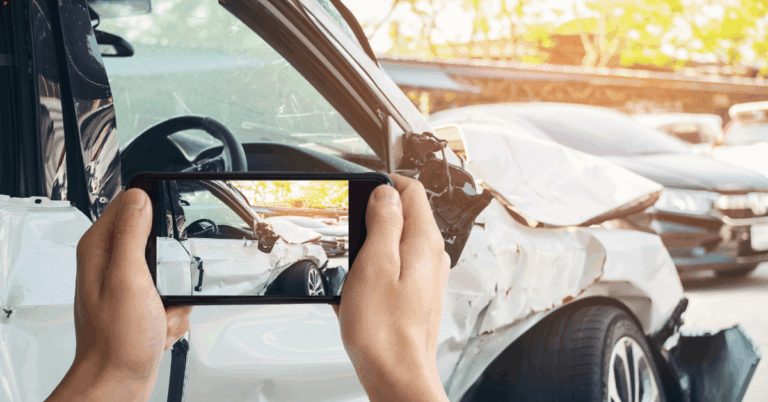 Step-by-Step Guide to Selling a Damaged Car or a Non-Runner vehicle someone taking a picture of a damaged car.